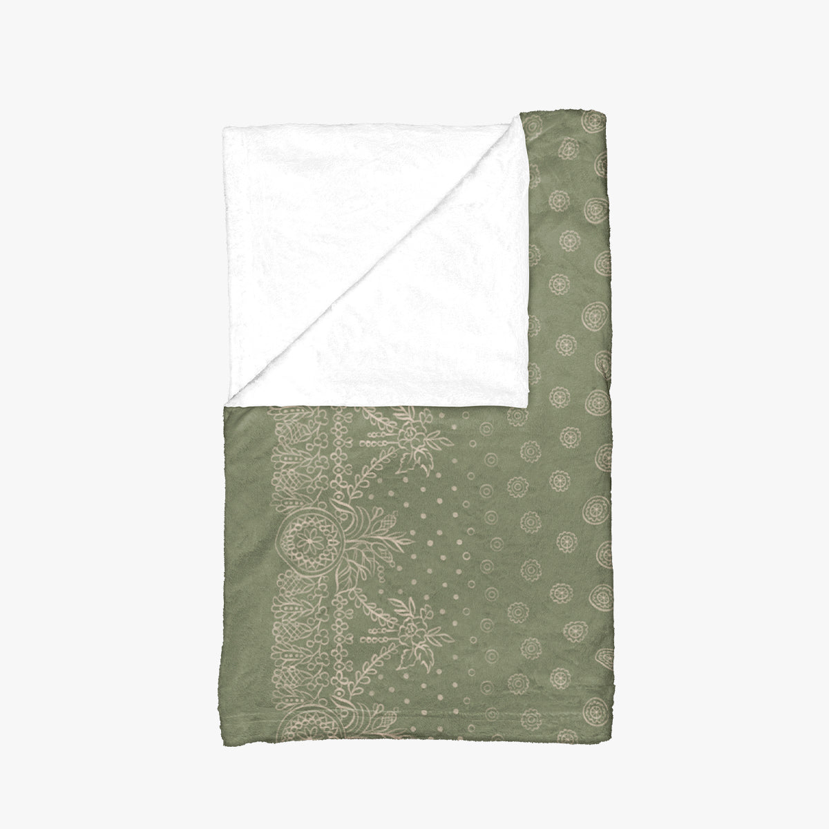 A green and white blanket with a white border, showcasing a gold design of craft symbols by Louis and Zélie.
