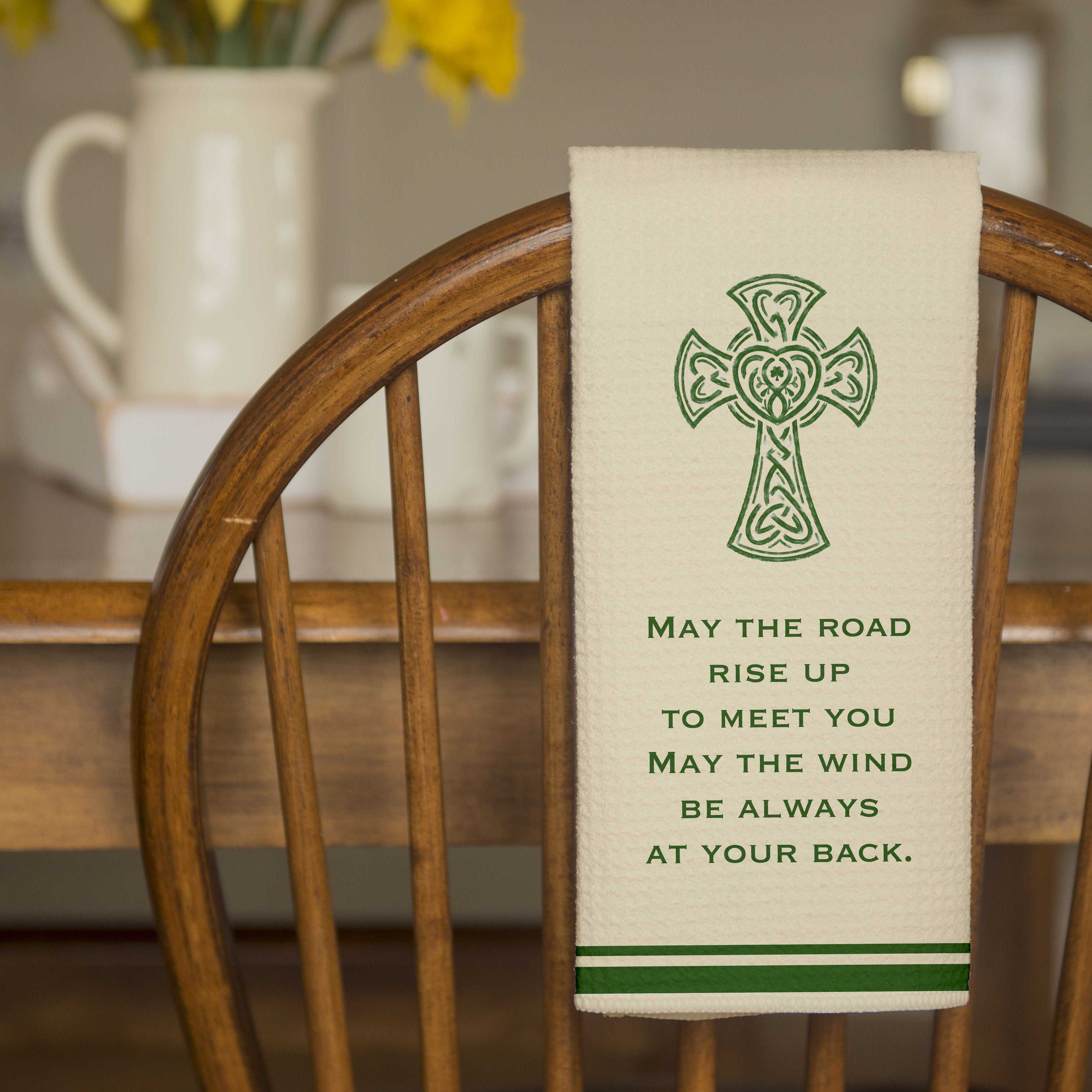 Irish Blessing Dish Towel with High Cross and words "May the road rise up to meet you may the wind be always at your back" - hanging over a chair